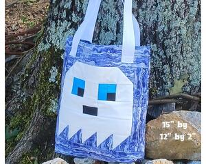A cute ghost quilted on a large tote bag. Perfect for trick or treating .Extra pocket on the outside, lots of room on the inside for candy. 